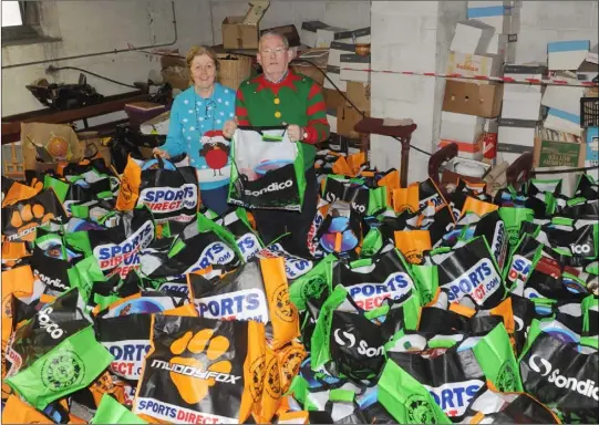  ??  ?? Rose Bailey and Tom Byrne with a range of Christmas Hampers at St. Patrick’s Parish Church. Photo by Aidan Dullaghan/Newspics.