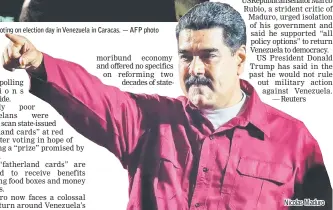  ?? — AFP photo ?? Maduro addresses supporters after the National Electoral Council (CNE) announced the results of the voting on election day in Venezuela in Caracas. Nicolas Maduro