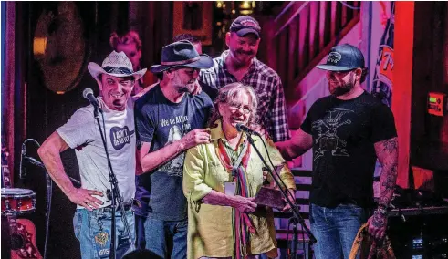  ?? [PHOTO PROVIDED BY CLAY BILLMAN] ?? Wilma Jenkins, center, the mother of the late Brandon Jenkins, accepts the Restless Spirit award on his behalf May 2 at Eskimo Joe’s in Stillwater during the Bob Childers’ Gypsy Cafe songwriter­s festival. From left are Brad Piccolo, John Cooper, Bo...