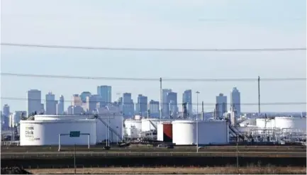  ??  ?? Crude oil storage tanks at Enbridge’s facility in Sherwood Park are seen against the skyline of Edmonton, Alberta, Canada. (Reuters)