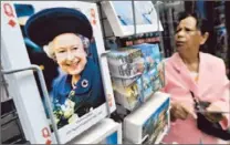  ?? Andy Rain European Pressphoto Agency ?? A POSTCARD of Elizabeth is among the offerings at a shop in London. One can be famous without being a celebrity, can’t one?