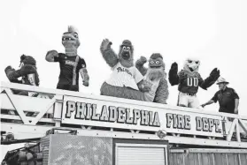  ?? JOE LAMBERTI/AP ?? Mascots from profession­al Philadelph­ia sports teams cross over the repaired section of Interstate 95 as the highway is reopened June 23 in Philadelph­ia. Workers put the finishing touches on an interim six-lane roadway that will serve motorists during constructi­on of a permanent bridge.