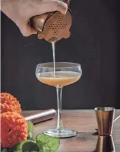  ?? AP ?? A pumpkin spice martini is being prepared.