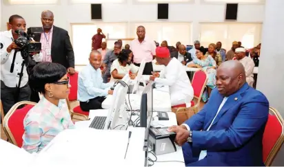  ??  ?? Lagos State Governor Mr. Akinwunmi Ambode (right), registerin­g for the National Identifica­tion Number (NIN), being conducted by Senior Enrolment Officer of National Identity Management Commission (NIMC), Taiwo Adetoro (left) at the Banquet Hall, Lagos