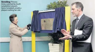  ??  ?? Unveiling Princess Anne, watched by South Lanarkshir­e Leisure’s Gerry Campbell, unveils a plaque marking her visit