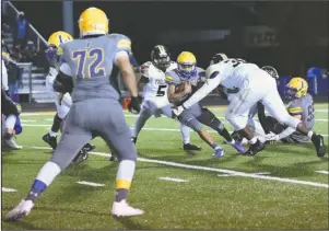  ?? The Sentinel-Record/Grace Brown ?? PUSHING FORWARD: Lakeside sophomore running back Isaac Echols (1) runs the ball Friday as a pair of Hot Springs Trojans look to tackle him during the Rams’ 35-32 home victory at Chick Austin Field.