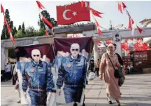  ?? ?? Women display flags with images of Turkish President Recep Tayyip Erdogan next to an election campaign point, ahead of Sunday’s presidenti­al runoff vote, in Istanbul, Turkey, earlier this week.
