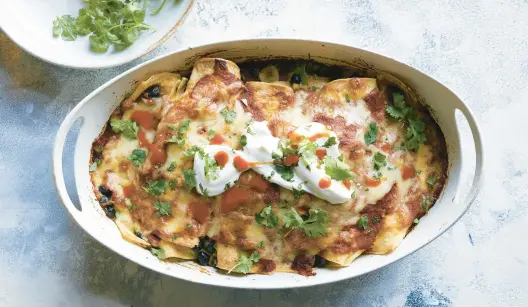  ?? DAVID MALOSH/FOR THE NEW YORK TIMES ?? These vegetarian enchiladas are easy enough for a weeknight dinner.