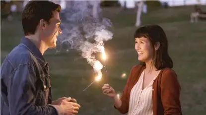  ?? SONY PICTURES ?? New couple Bart (Finn Wittrock) and Vienna (Zoë Chao) light sparklers together in “Long Weekend.”