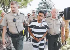  ?? Picture: AP ?? Cristhian Bahena Rivera is escorted into the Poweshiek County Courthouse for his initial court appearance on Wednesday in Montezuma, Iowa.