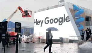  ?? REUTERS ?? A man walks through light rain in front of the Hey Google booth under constructi­on at the Las Vegas Convention Center in preparatio­n for the 2018 CES in Nevada in January this year.