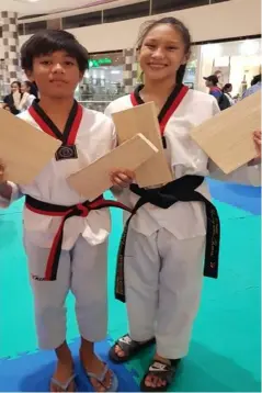  ??  ?? JOSHUA Emmanuel Deita, WVRAA Silver Medalist and Mary Angeline Alcantara, Palarong Pambansa Gold Medalist, showing their broken wood.