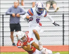  ?? Matthew Brown / Hearst Connecticu­t Media ?? Greenwich’s David Faugno brings down Danbury’s Bernie Delacruz on Saturday at Cardinal Stadium in Greenwich.