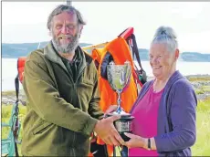  ??  ?? Tom Colville collecting the New Zealand trophy.