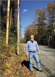  ?? MARY ESCH - THE ASSOCIATED PRESS ?? Hamilton County Highway Superinten­dent Tracy Eldredge stands on a roadside in state Forest Preserve land where local officials want to put a bike lane in Piseco Lake. The project stalled because of the state constituti­onal protection of Adirondack...