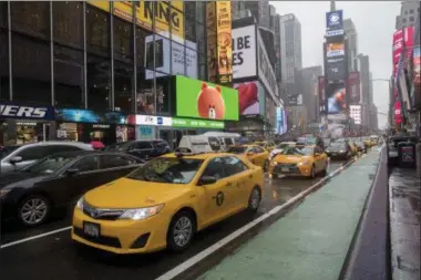  ?? THE ASSOCIATED PRESS PHOTOS ?? In this Thursday, May 25, 2017, photo, traffic makes it’s way down Seventh Avenue in New York’s Times Square.