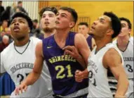  ?? TANIA BARRICKLO — DAILY FREEMAN ?? Rhinebeck’s Rob Veith, middle, looks for rebound during Hawks’ semifinal loss to Spackenkil­l.