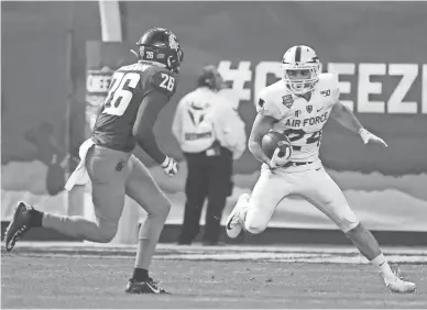  ??  ?? Air Force's Kadin Remsberg (24) rushes upfield against Washington State's Bryce Beekman (26) during the first half of the Cheez-It Bowl at Chase Field in Phoenix. Visit azcentral.com/sports for a recap.