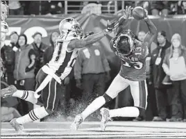  ?? Corey Perrine Getty Images ?? PHILADELPH­IA’S NELSON AGHOLOR can’t make a catch in the end zone in the fourth quarter under pressure from New England’s J.C. Jackson.