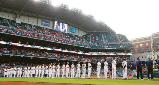  ?? Karen Warren / Staff photograph­er ?? The Astros line up during the national anthem ahead of Thursday night’s game, the first at Minute Maid Park in 527 days to have fans in the stands.
