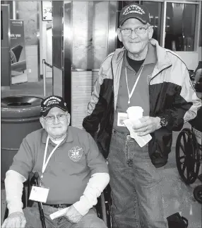  ?? Photo by Mike Eckels ?? William Townsley (left), a World War II Army veteran, and his son Mark, a Vietnam Navy veteran, get ready to take a trip together aboard the 2017 O&A Honor Flight which departed Northwest Arkansas Regional Airport in Highfill April 19.