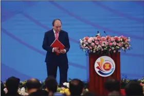  ?? (AP/Hau Dinh) ?? Vietnamese Prime Minister Nguyen Xuan Phuc leaves the stage Friday after delivering a speech at the opening ceremony of the 36th Associatio­n of Southeast Asian Nations Summit in Hanoi, Vietnam.