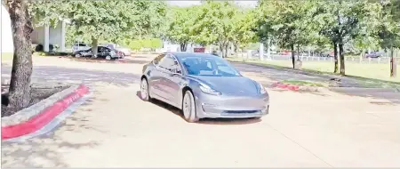  ?? Picture: COURTESY OF PARTH DHEBAR VIA REUTERS ?? A Tesla 3 model is remotely driven with the company’s phone app in Austin, Texas in this still image taken from social media video.