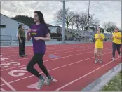  ??  ?? Girls racing in Miracle Mile with Coach Ed Nieves, far left.