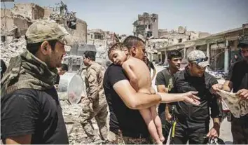  ?? Reuters ?? An image nominated for the Picture of the Year at the World Press photo contest shows an unidentifi­ed young boycarried out of the last Daesh-controlled area in the Old City of Mosul, Iraq.