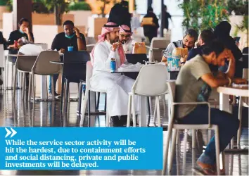  ?? AFP ?? People sit at a cafe in a mall in the Saudi capital Riyadh. As economies relax Covid-19-related lockdowns, business is picking up. However, challenges remain, experts say.