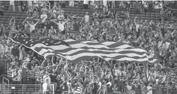  ?? MARK J. REBILAS, USA TODAY SPORTS ?? American soccer fans wave a flag at the Gold Cup final in July in Santa Clara, Calif.