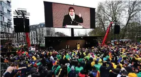  ??  ?? Supporters listen to a speech by Catalonia’s deposed regional president Carles Puigdemont in Brussels yesterday. Photo: Emmanuel Dunand/AFP/ Getty Images