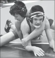  ?? NWA Democrat-Gazette/FLIP PUTTHOFF ?? Cameron Hicks (left) of Van Buren and Jaxon Davis of Rogers Heritage compete Saturday in the Big West wrestling tournament at Fayettevil­le High School.