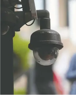  ?? JUSTIN SULLIVAN / GETTY IMAGES ?? A video surveillan­ce camera hangs on a building. Canada's privacy commission­ers are
calling for laws limiting the use of facial recognitio­n technology by police forces.