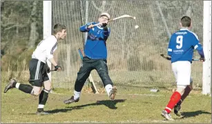  ??  ?? Lovat keeper Stuart MacDonald making another save watched by teammate Daniel Grieve and Kyles Athletic’s Dunky Kerr.