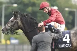  ??  ?? Roaring Lion claims the Irish Champion Stakes under Oisin Murphy