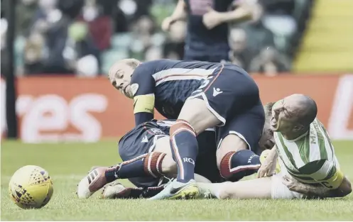  ??  ?? Andrew Davies drives his boot into Scott Brown’s groin, an action which earned the Ross County skipper a two-match ban.