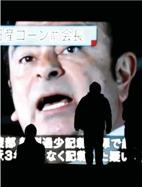  ??  ?? Big news: A street monitor in Tokyo broadcasts news reporting the indictment and re-arrest of ousted Nissan chairman Carlos Ghosn