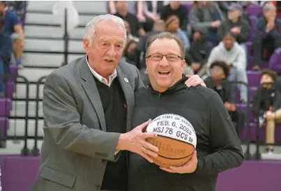  ?? BALTIMORE SUN AMY DAVIS/ ?? Former St. Maria Goretti basketball coach Cokey Robertson, left, congratula­tes Mount Saint Joseph basketball coach Pat Clatchey, who recently passed Robertson for third place in all-time wins for a Maryland boys high school basketball coach, on Wednesday.