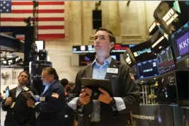  ?? SETH WENIG — THE ASSOCIATED PRESS ?? Traders work on the floor at the New York Stock Exchange in New York on Tuesday.