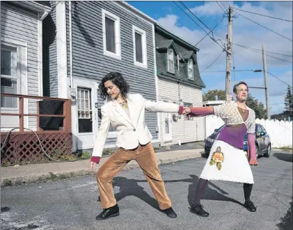  ?? JARED REID PHOTO ?? Dancers Louise Moyes and Karen Fennell perform in the middle of Young Street. Some neighbourh­ood residents watched the action in the street from their open windows.