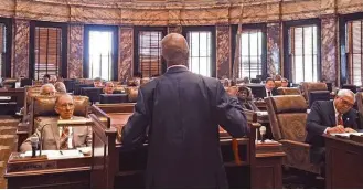  ?? Jeff Amy / Associated Press ?? Mississipp­i Sen. Hillman Frazier brandishes a sheathed sword during debate in March over House Bill 786, which allows guns in churches. Frazier opposed the bill, recounting the story of Jesus healing a servant of a high priest after a disciple cut off...