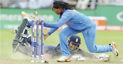  ?? — AP ?? LONDON: England’s Jenny Gunn slides into the crease as India’s Rajeshwari Gayakwad unsuccessf­ully attempts to run her out during the ICC Women’s World Cup 2017 final match between England and India at Lord’s in London.