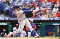  ?? Rich Schultz / Getty Images ?? The Mets’ Pete Alonso hits a three-run home run against the Phillies in the fifth inning of Game 2 of Sunday’s doublehead­er.