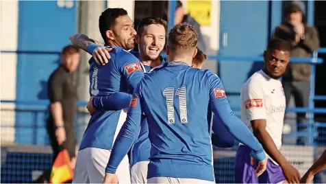  ?? All photograph­s by Pete Stonier ?? Lewis Short is mobbed after scoring Leek’s winner against Ramsbottom United on Saturday.