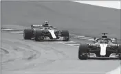  ?? ASSOCIATED PRESS ?? MERCEDES DRIVER VALTTERI BOTTAS of Finland follows teammate Lewis Hamilton of Britain, right, through a curve during the third free practice session for the Austrian Formula One Grand Prix at the Red Bull Ring racetrack in Spielberg, southern Austria,...