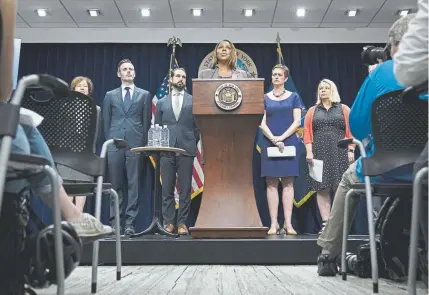  ?? Drew Angerer, Getty Images ?? New York Attorney General Letitia James, center, speaks during a news conference Tuesday in New York City. James announced that New York, Colorado and seven other states have filed a lawsuit seeking to block the proposed merger between Sprint and T- Mobile. James said the merger would deprive customers of the benefits of competitio­n and potentiall­y drive up prices for cellphone service.