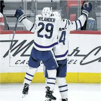  ?? JOSE JUAREZ/ THE ASSOCIATED PRESS ?? William Nylander grabs on to Auston Matthews in celebratio­n of Matthews’ late game- winner against the Red Wings, Sunday in Detroit. Matthews scored the goal with 30 seconds left in the third period to give the Maple Leafs a 3- 2 win.