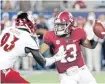  ?? [AP PHOTO] ?? Tua Tagovailoa went 12-of-16 passing for 227 yards with two touchdown in a 51-14 win over Louisville on Sept. 1.