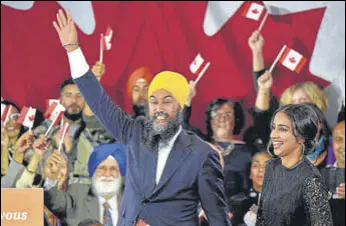  ?? AFP ?? NDP leader Jagmeet Singh along with his wife Gurkiran Kaur acknowledg­e the cheers of supporters at an election night party in Burnaby BC, Canada.